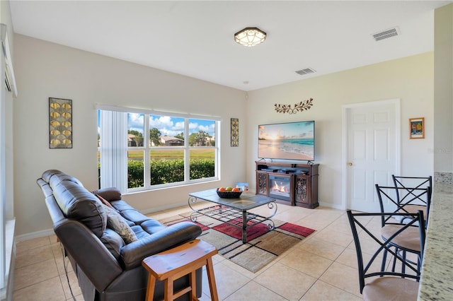 2641 Meadow View Ct, Kissimmee, FL 34746 - living area with light tile patterned floors and a glass covered fireplace