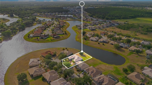 2641 Meadow View Ct, Kissimmee, FL 34746 - aerial view of property and surrounding area featuring property boundaries highlighted, a nearby body of water, and nearby suburban area