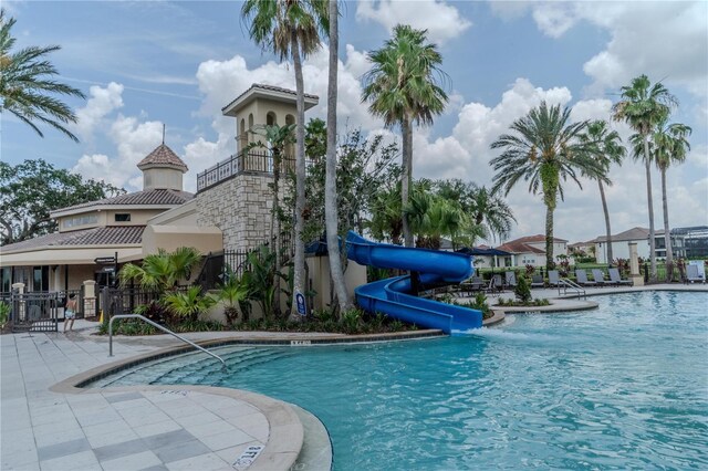 2641 Meadow View Ct, Kissimmee, FL 34746 - community pool with a water slide and a patio
