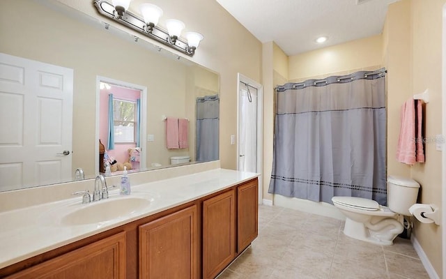 bathroom with tile patterned flooring, vanity, toilet, baseboards, and curtained shower