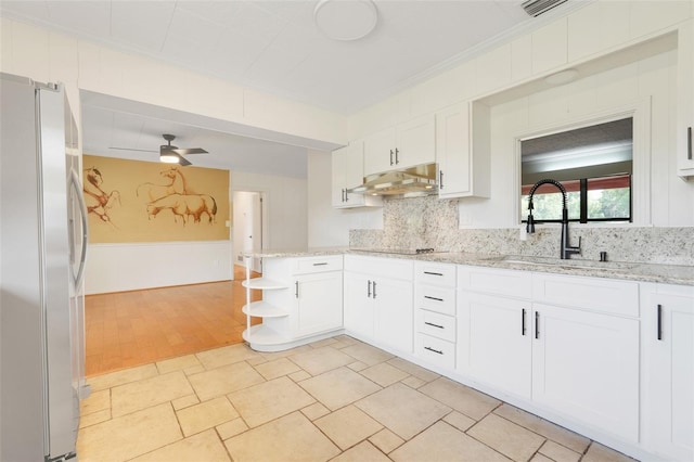 274 W Kings Hwy, Center Hill, FL 33514 - kitchen with a sink, white cabinets, freestanding refrigerator, and under cabinet range hood