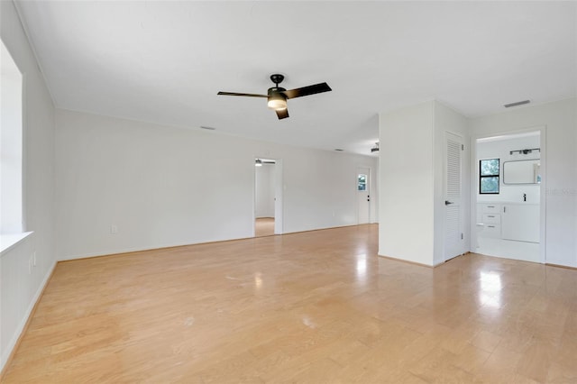 274 W Kings Hwy, Center Hill, FL 33514 - empty room with visible vents, light wood-style flooring, ceiling fan, and baseboards