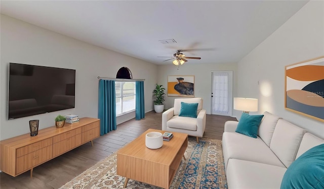 living area with wood finished floors, visible vents, and ceiling fan