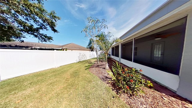 view of yard with fence and a sunroom