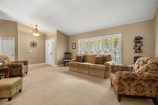 living room featuring baseboards, lofted ceiling, and light carpet