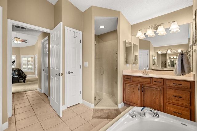 bathroom with tile patterned floors, a shower stall, baseboards, and vanity