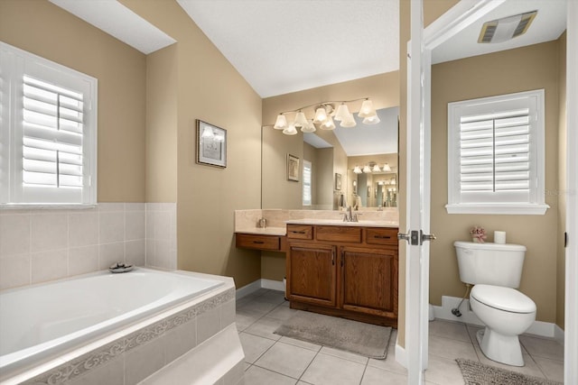 bathroom featuring tile patterned flooring, vanity, toilet, visible vents, and a bath