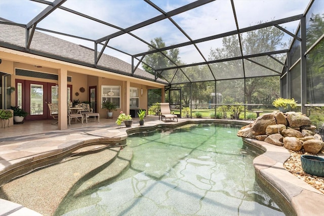 outdoor pool featuring french doors, a patio, and a lanai