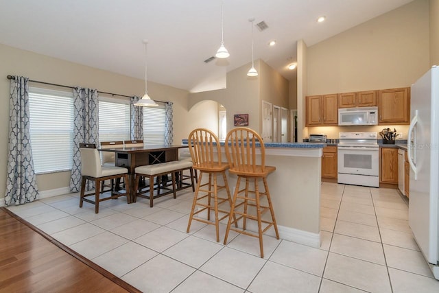 2539 Caithness Way, Clermont, FL 34714 - kitchen featuring white appliances, baseboards, arched walkways, high vaulted ceiling, and a breakfast bar