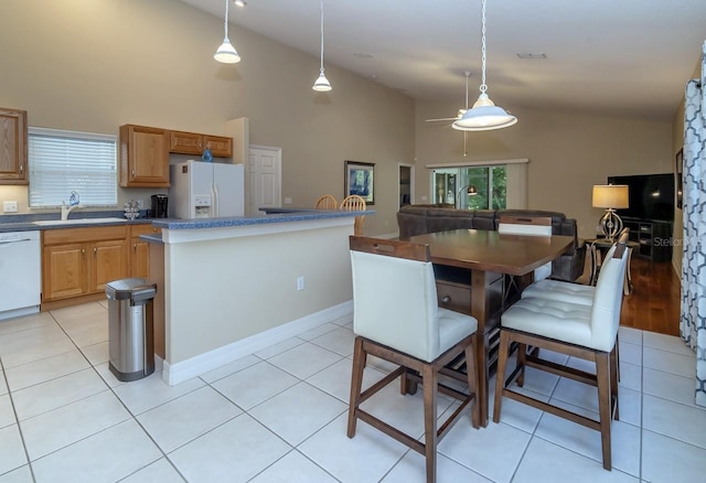 2539 Caithness Way, Clermont, FL 34714 - kitchen featuring white appliances, a sink, high vaulted ceiling, a center island, and pendant lighting