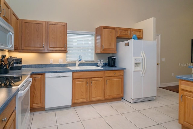 2539 Caithness Way, Clermont, FL 34714 - kitchen featuring white appliances, a sink, dark countertops, light tile patterned floors, and brown cabinets