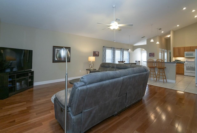 2539 Caithness Way, Clermont, FL 34714 - living area featuring arched walkways, a ceiling fan, light wood-style flooring, baseboards, and recessed lighting