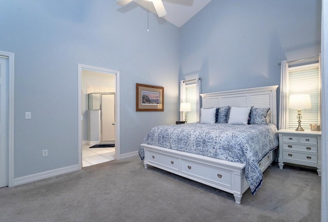 2539 Caithness Way, Clermont, FL 34714 - carpeted bedroom featuring high vaulted ceiling, baseboards, ensuite bathroom, and a ceiling fan