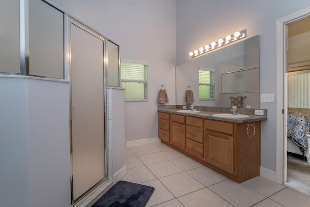 2539 Caithness Way, Clermont, FL 34714 - full bath featuring tile patterned floors, double vanity, baseboards, a shower with door, and ensuite bathroom