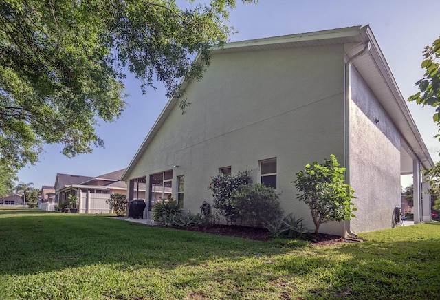 2539 Caithness Way, Clermont, FL 34714 - view of home's exterior with a yard and stucco siding