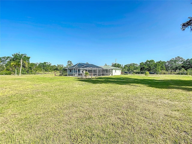 view of yard with glass enclosure