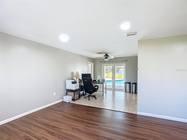 office with visible vents, baseboards, ceiling fan, and wood finished floors