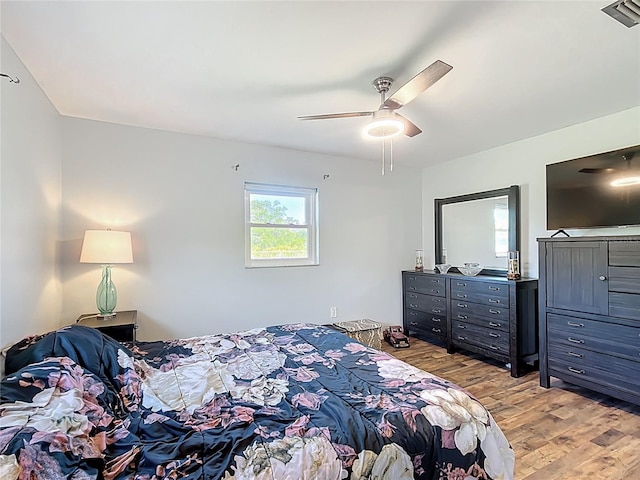 bedroom with ceiling fan, visible vents, and light wood-style flooring
