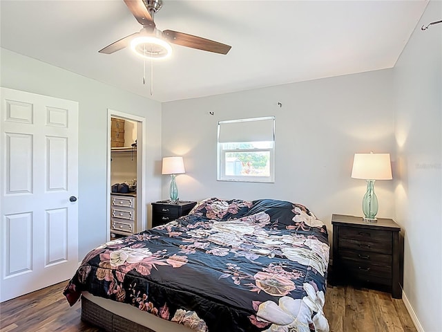 bedroom with baseboards, ceiling fan, a closet, and wood finished floors