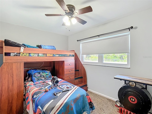 carpeted bedroom featuring baseboards and ceiling fan