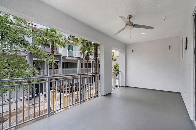 view of patio featuring ceiling fan and a balcony