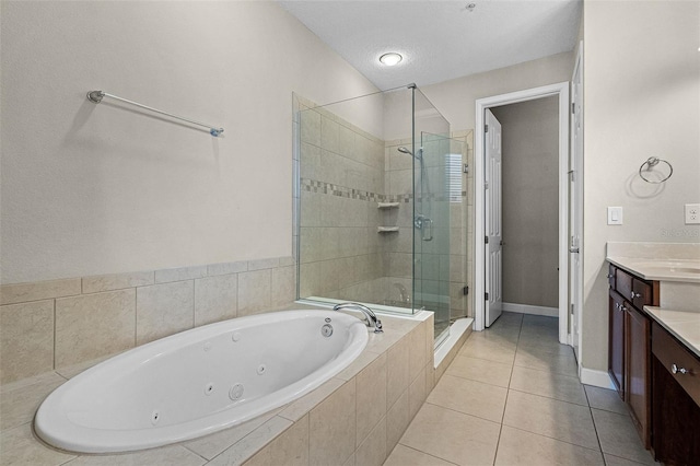 full bath with vanity, tile patterned flooring, baseboards, a jetted tub, and a stall shower