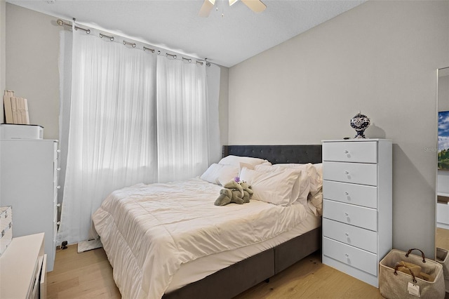 bedroom with light wood-style flooring and ceiling fan