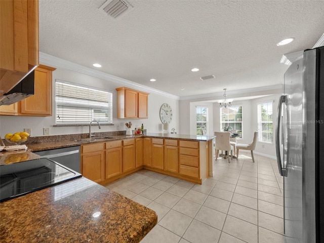 951 Chapman Loop, The Villages, FL 32162 - kitchen featuring freestanding refrigerator, a sink, a peninsula, crown molding, and light tile patterned flooring