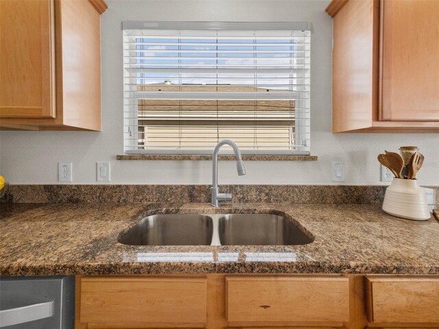 951 Chapman Loop, The Villages, FL 32162 - kitchen featuring a sink and dark stone countertops