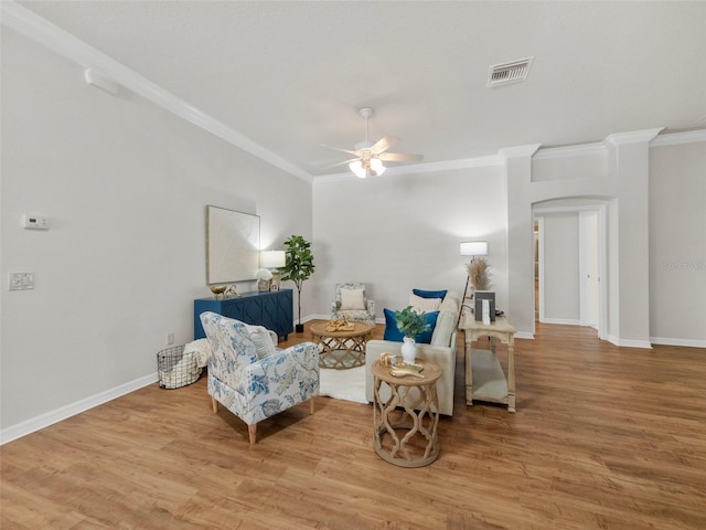 951 Chapman Loop, The Villages, FL 32162 - living area with a ceiling fan, crown molding, wood finished floors, and baseboards