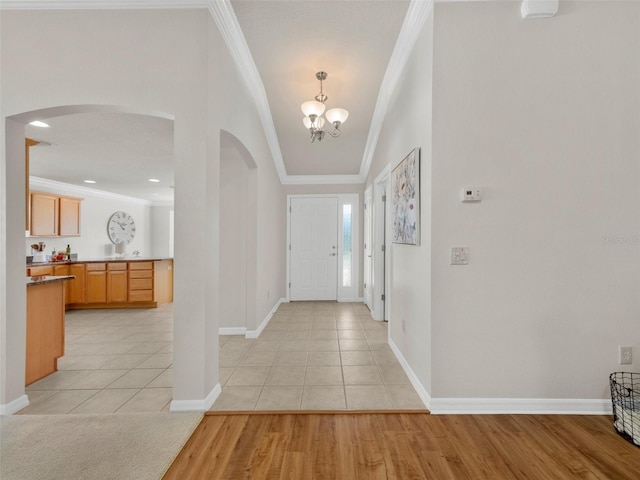 951 Chapman Loop, The Villages, FL 32162 - foyer with arched walkways, ornamental molding, a chandelier, and baseboards