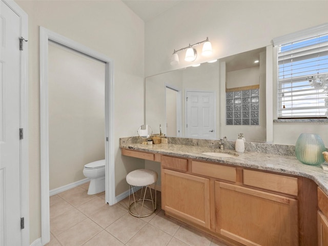 951 Chapman Loop, The Villages, FL 32162 - bathroom with tile patterned flooring, vanity, toilet, and baseboards