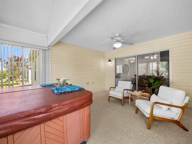 951 Chapman Loop, The Villages, FL 32162 - sitting room featuring carpet floors, a ceiling fan, wood walls, and healthy amount of natural light