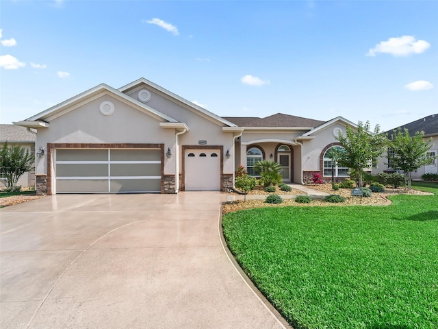 ranch-style house with an attached garage, stone siding, stucco siding, concrete driveway, and a front yard