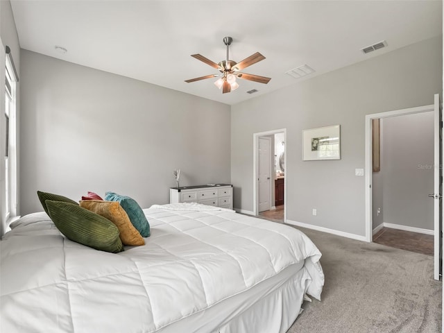 carpeted bedroom with ceiling fan, baseboards, and visible vents
