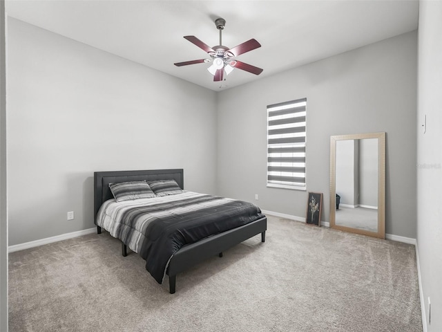carpeted bedroom featuring baseboards and ceiling fan