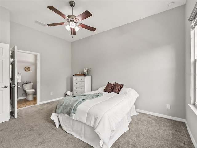 bedroom with carpet, ensuite bath, visible vents, ceiling fan, and baseboards