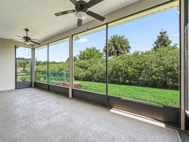 unfurnished sunroom with ceiling fan