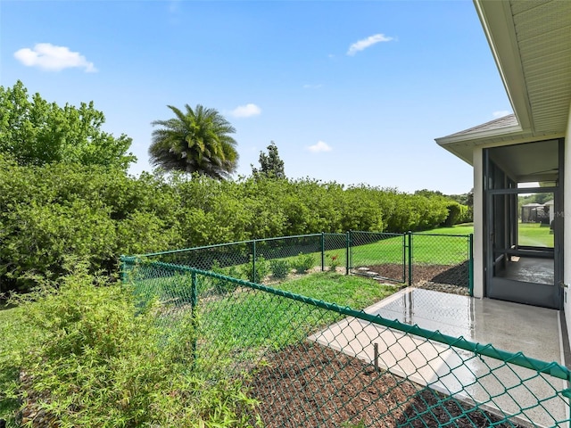 view of yard with a fenced backyard and a sunroom