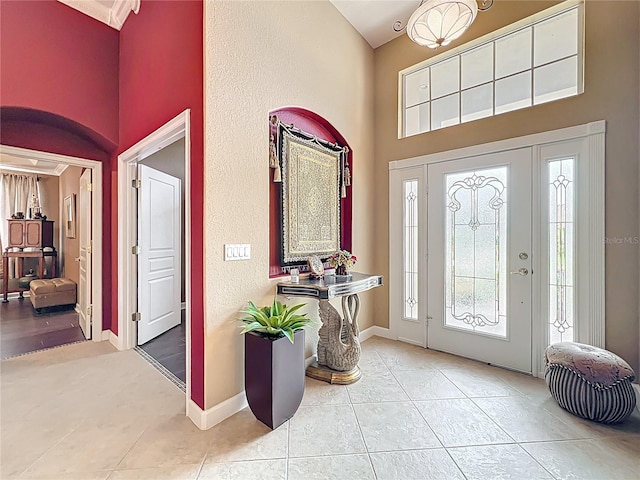 1473 Lakemist Ln, Clermont, FL 34711 - entrance foyer with baseboards, a towering ceiling, and light tile patterned flooring