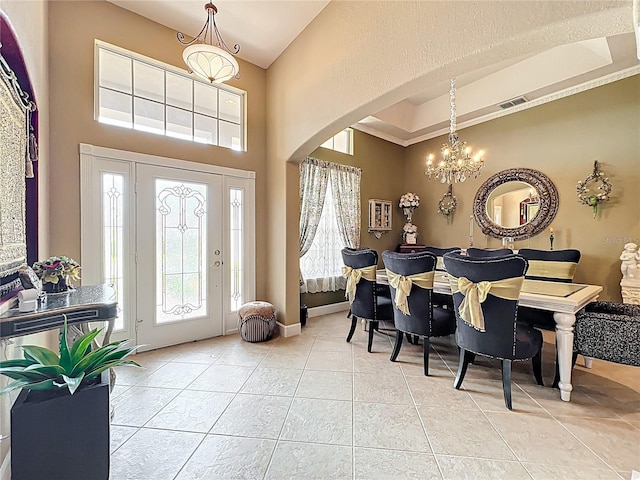 1473 Lakemist Ln, Clermont, FL 34711 - entryway featuring visible vents, a towering ceiling, arched walkways, light tile patterned floors, and a notable chandelier