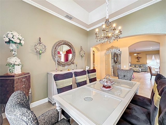 1473 Lakemist Ln, Clermont, FL 34711 - dining room featuring visible vents, crown molding, arched walkways, baseboards, and a notable chandelier