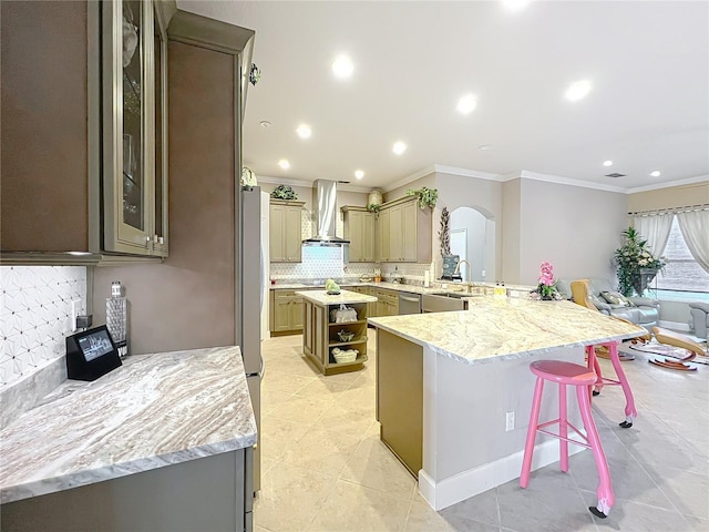 1473 Lakemist Ln, Clermont, FL 34711 - kitchen featuring ornamental molding, open shelves, a breakfast bar area, wall chimney range hood, and arched walkways