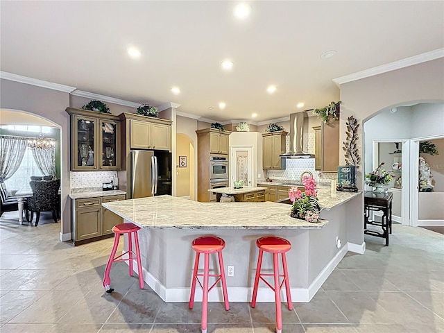 1473 Lakemist Ln, Clermont, FL 34711 - kitchen with wall chimney range hood, arched walkways, ornamental molding, and stainless steel appliances