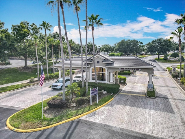 1473 Lakemist Ln, Clermont, FL 34711 - view of front of house with a tiled roof, stucco siding, an attached carport, and decorative driveway