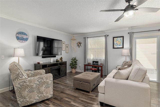 living room with a textured ceiling, dark wood-style flooring, baseboards, ceiling fan, and ornamental molding