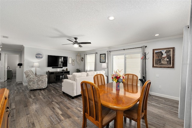 dining area featuring dark wood-style flooring and crown molding