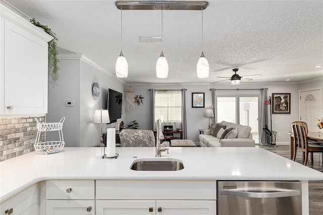 kitchen featuring dishwasher, crown molding, wood finished floors, and a sink