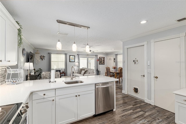 kitchen featuring stainless steel appliances, open floor plan, ornamental molding, and a sink