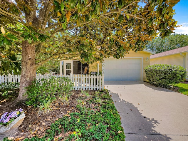 2102 Estevez Dr, Lady Lake, FL 32159 - view of property hidden behind natural elements featuring driveway and a garage